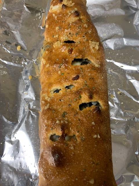 A loaf of bread sitting on tin foil.