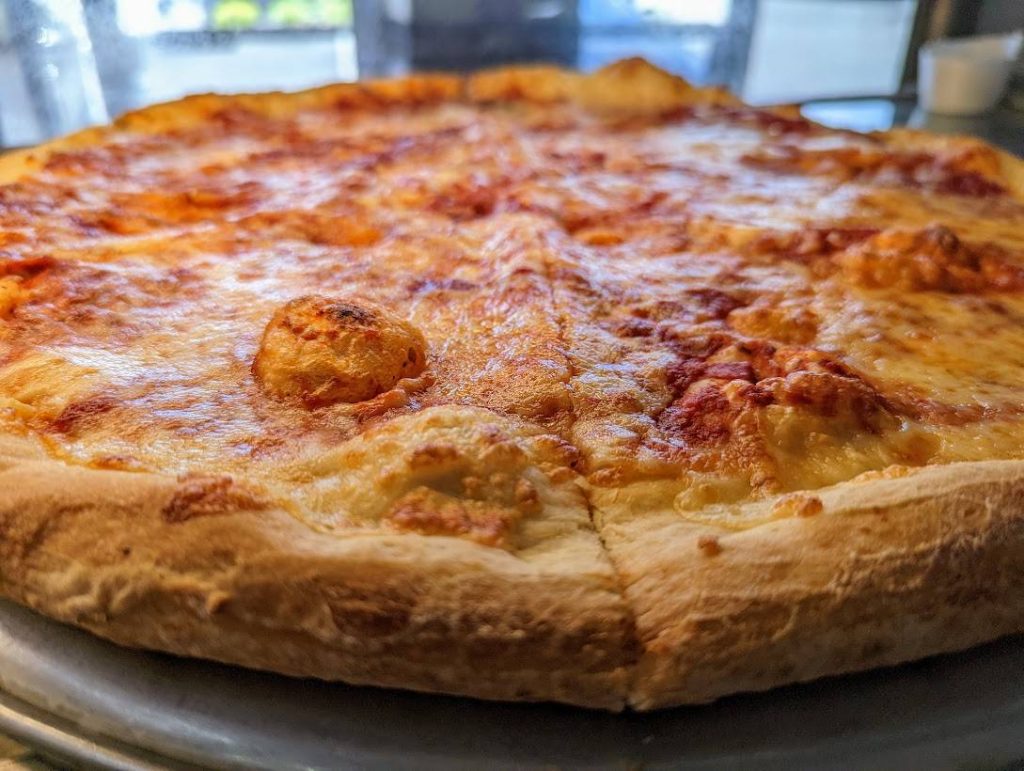 A pizza sitting on a metal pan.