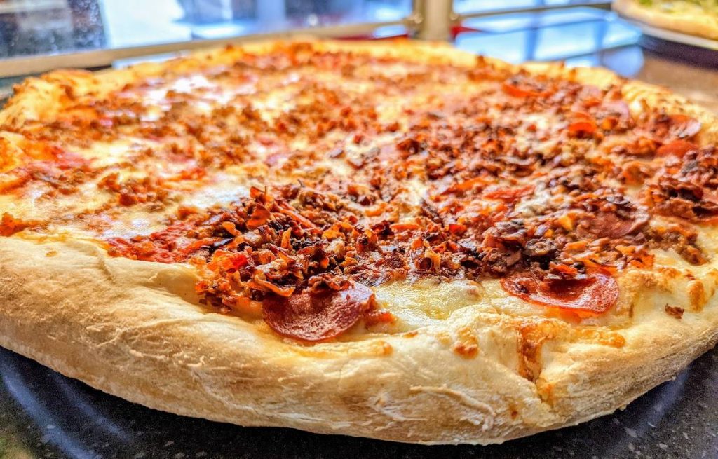 A large pizza sitting on a table.